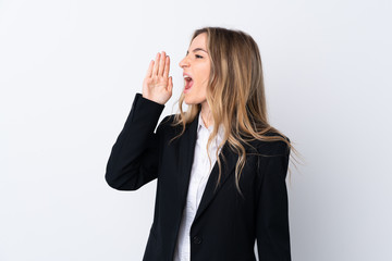 Young business woman over isolated white background shouting with mouth wide open