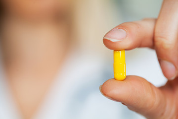 Close up of female doctor holding pill