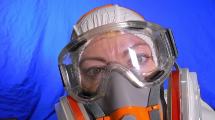 Scientist virologist in respirator. Slow motion. Woman close up look wearing protective medical...