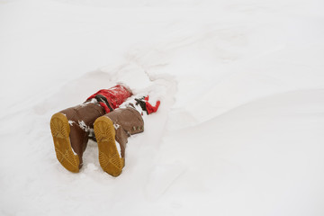 Legs wearing snowboard shoos of person buried by an avalanche. Danger extreme concept