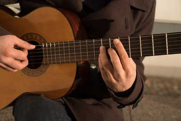 Fototapeta na wymiar Crop view of male artist playing guitar