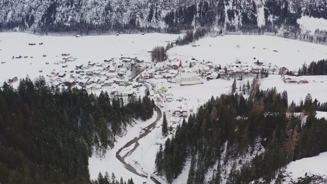 aerial view flying forward into the village holzgau in austria with nice church