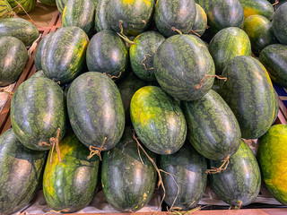 Heap of green watermelons for sale at fruit market