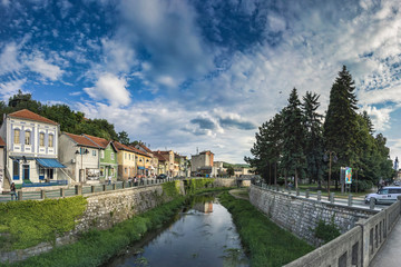 Fototapeta na wymiar Old downtown of Knjazevac city in eastern Serbia. Beautiful view from the central bridge on the Timok river, HDR stitched panorama. 