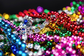 Selective focus on colorful plastic festival beads.  Blurred foreground.  Blurred background.  Bokeh.