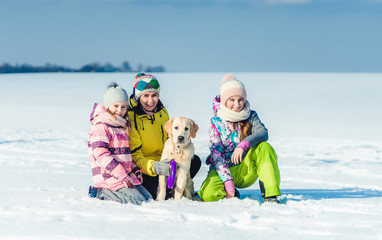 Mother and daughters with dog
