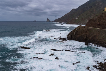 View to waves and cliff near Roque de Las Bodegas beach in the area of Taganana, Tenerife Island,  Spain