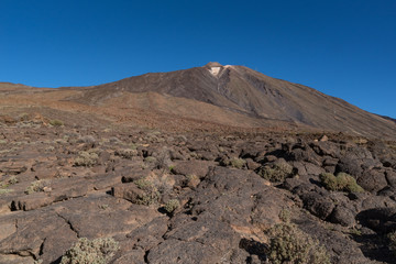 Pico del Teide mountain volcano summit view form lava field near Roques de García unique rock formation, Teide National Park, Tenerife, Canary Islands, Spain