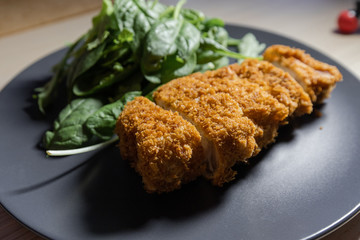 Close-up side view of tonkatsu, pork cutlet.