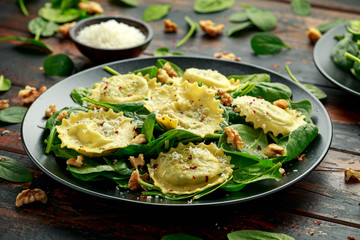 Italian ravioli pasta stuffed with spinach, creamy ricotta cheese, walnuts. Healthy Vegetarian food - Powered by Adobe