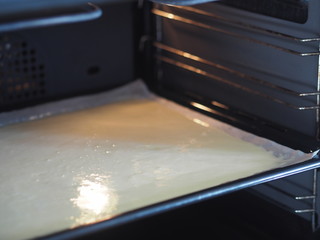 Homemade baking batter on the counter in a black kitchen oven for cooking biscuit. Homemade dessert sweet roll.