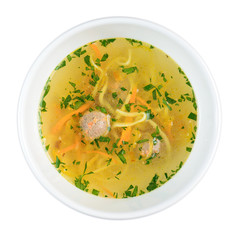 Vegetables Broth with Chicken Meatball and Herbs on a white background in a plate. The view from a top.