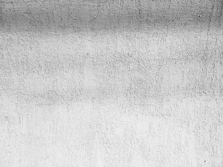 Old white concrete wall. Paint peeling off the walls.