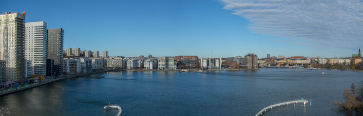 Sunny winter view over the bay between the Stockholm districts Marievikshamn, Årstadal, Tantolunden, Hornstull, Liljeholmen and the Årsta train bridges