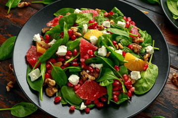 Orange Grapefruit salad with spinach, walnuts, pomegranate seeds and feta cheese. healthy food