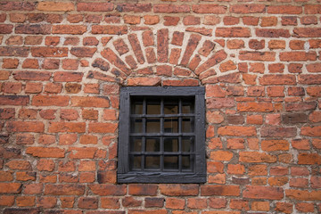 Fototapeta na wymiar Window in a brick wall from the 1600s in Stockholm