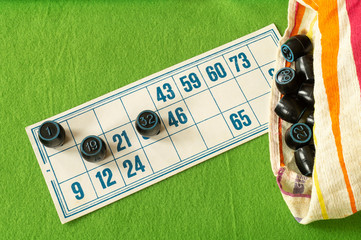 Card lotto with barrel and bag неа green table