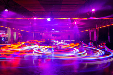 Blurry colourfull light lines from the fast moving bumper cars at the Sassenheim town fair in the...