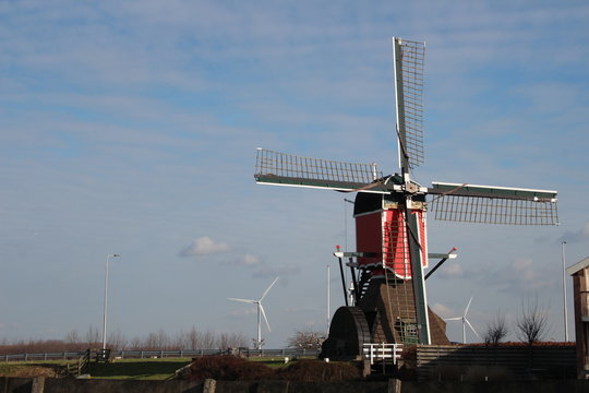 red colourd old four corner wooden windmill at Zoeterwoude in the Netherlands