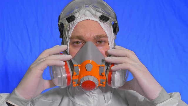Scientist virologist in respirator. Slow motion. Man close up look, wearing protective medical mask. Concept health safety N1H1 virus protection coronavirus epidemic 2019 nCoV. Chroma key blue film.