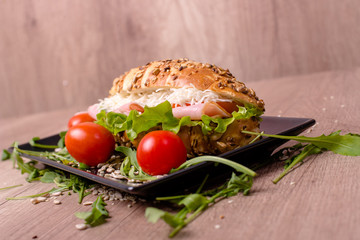 Ham sandwich on a wooden table