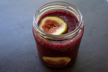 Breakfast acai superfoods smoothies bowl with fresh fig