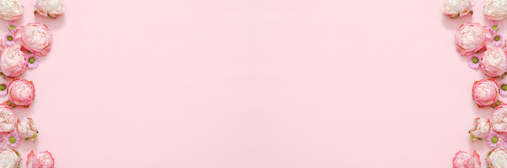 Pink floral background. Natural composition. Daisy roses heads frame design. Empty space.