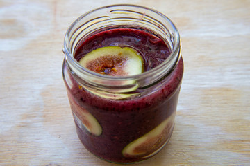 Breakfast acai superfoods smoothies bowl with fresh fig