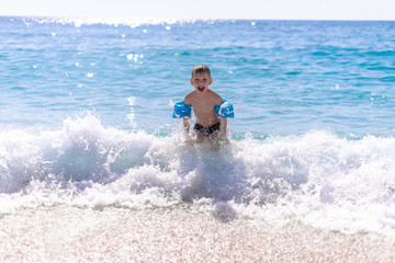 One boy is playing on the beach