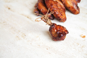  fried chicken wings on a marble surface, with spices and herbs.