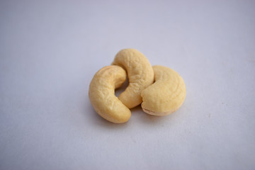 Fototapeta na wymiar cashew nuts heap on white background Full depth of field Close-Up Stock Photography Image