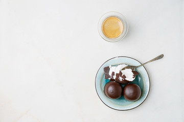 Whole and cracked Chocolate covered marshmallows, german 