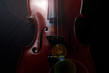The abstract art design background of violin on grunge surface background,lens flare effect,blurry light around