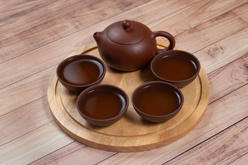 Tea ceremony with clay tea set on wooden stand