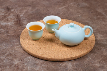 Porcelain tea set on cork stand. Chinese tea ceremony
