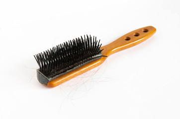 Hair loss problem with the wooden handle hairbrush on white background