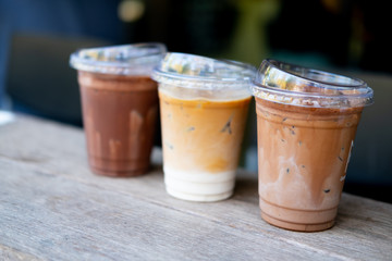 Three glasses of iced coffee drinks on table.