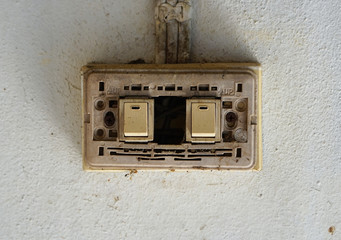  Old power switch for lamp, Old light switch without cover on the white cement wall.