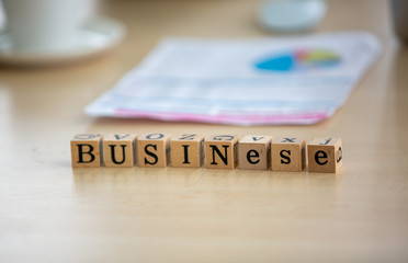 Row of lumber with the word business on the table.