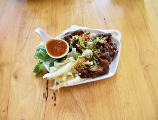 Boiled meat sauce to dip vegetables in white dish.