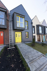 Modern hitech townhouses in a residential building settlement with green outdoor facilities in diffrent styles along the road