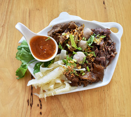Boiled meat sauce to dip vegetables in white dish.