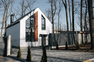 Modern hitech townhouses in a residential building settlement with green outdoor facilities in diffrent styles along the road