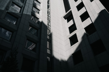 Abstract part of a cement office center building windows with light and shadow on it