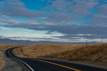 Road is going between hills. American trip