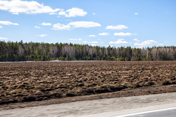 Plowing field uder the cloudy sky in may day