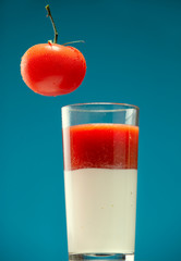 Tomato and glass with tomato juice and sour cream
