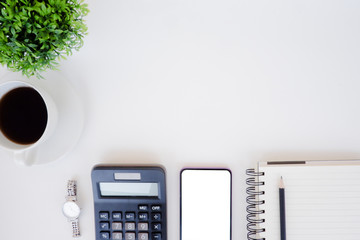 Top view white office desk table with the office equipments, computer keyboard and other office supplies on the modern space, flat lay.