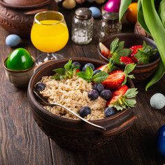 Homemade oatmeal granola or muesli with fresh berries for healthy easter morning breakfast, selective focus. Healthy food background.