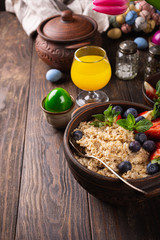 Homemade oatmeal granola or muesli with fresh berries for healthy easter morning breakfast, selective focus. Healthy food background, copy space.
